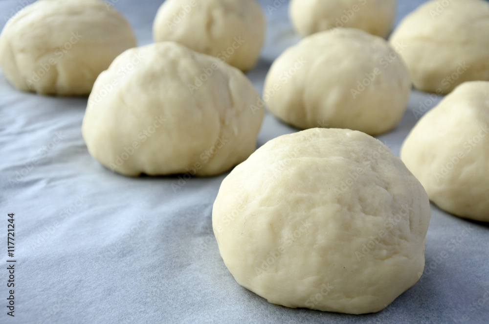 Close up view of round pieces of dough Bread Rolls