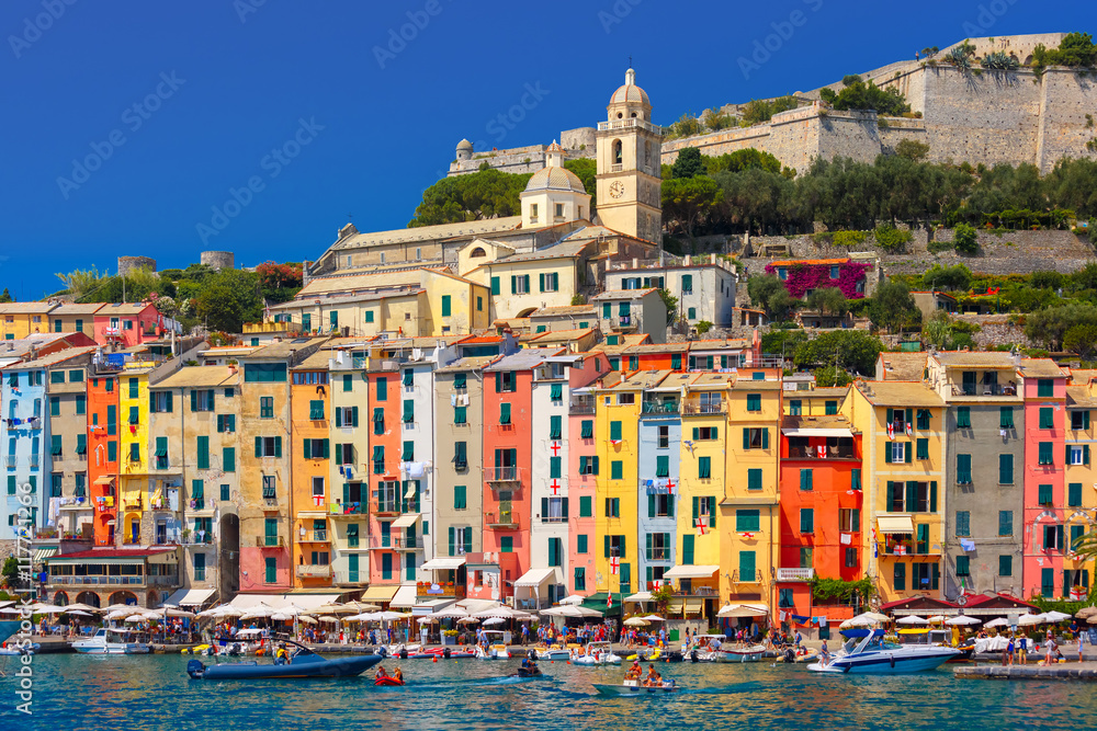 Panoramic view of colorful picturesque harbour of Porto Venere, San Lorenzo church and Doria Castle on the background, La Spezia, Liguria, Italy.