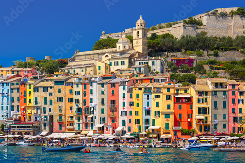 Panoramic view of colorful picturesque harbour of Porto Venere, San Lorenzo church and Doria Castle on the background, La Spezia, Liguria, Italy.