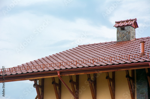 Roof with rain gutter and chimney