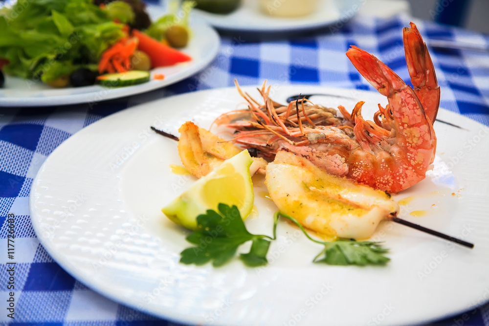 grilled king prawns and a skewer with squid