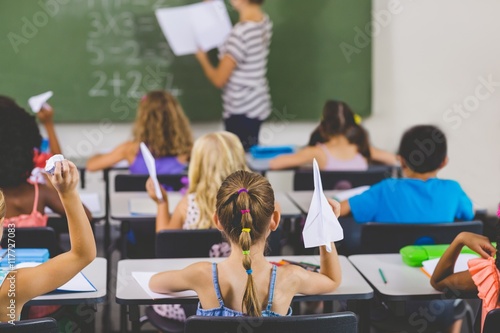 Fotografie school kids with paper planes in classroom