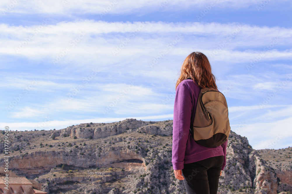 young woman on top of the mountain on a sunny day young woman on top of the mountain on a sunny day