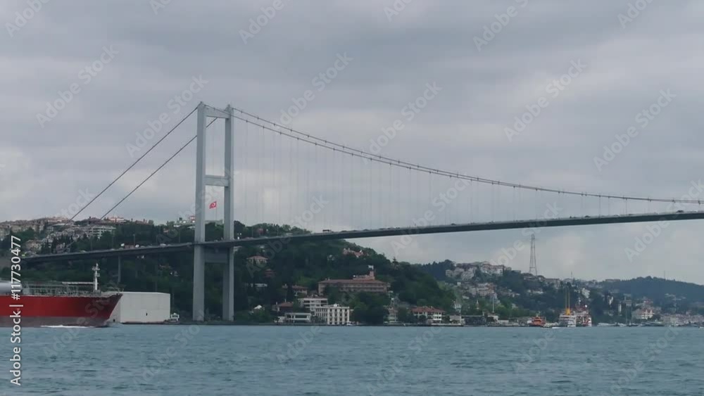Cargo ship sails under the bridge Ataturk. Bosphorus. Istanbul. Turkey. Cargo ship sails under the bridge Ataturk. Bosphorus. Istanbul. Turkey.