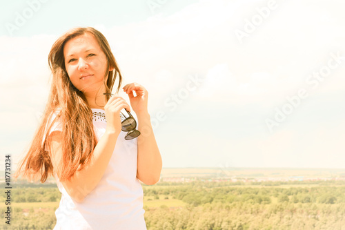 Young successful female Model on blue sky background