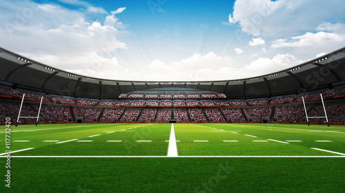 rugby stadium with fans and green grass at daylight