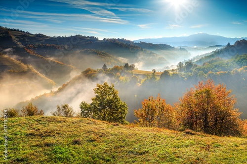 Colorful autumn landscape with misty valley,Holbav,Transylvania,Romania,Europe photo