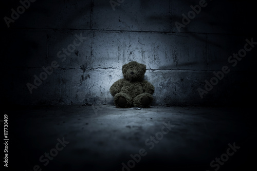 Teddy bear sitting in haunted house,Scary background for book cover