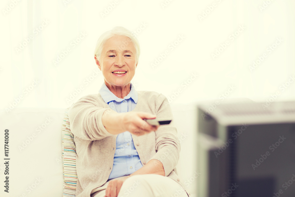happy senior woman watching tv at home happy senior woman watching tv at home