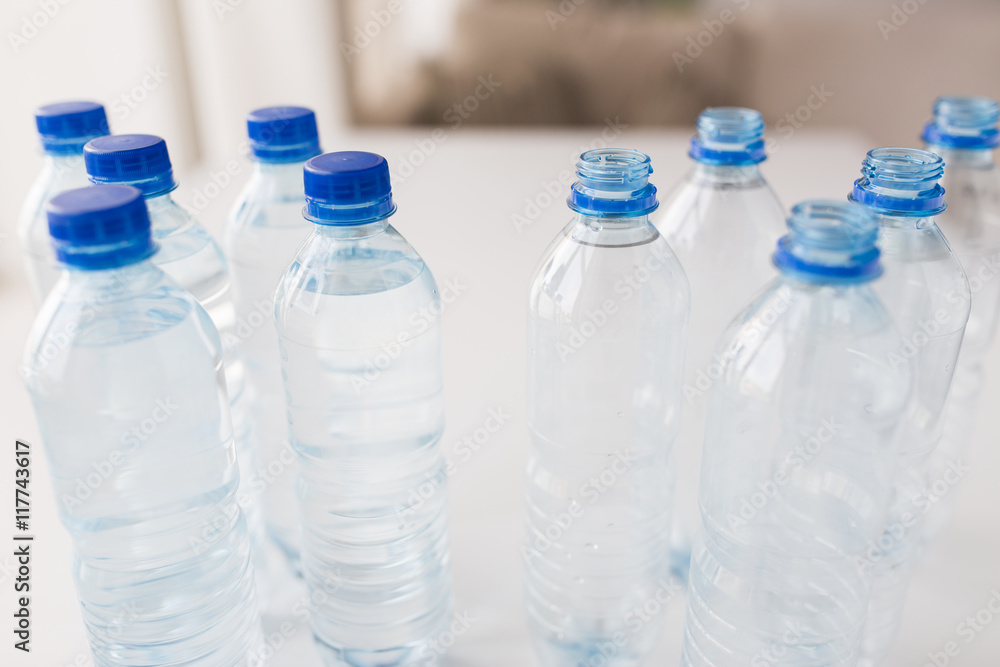 close up of bottles with drinking water on table close up of bottles with drinking water on table