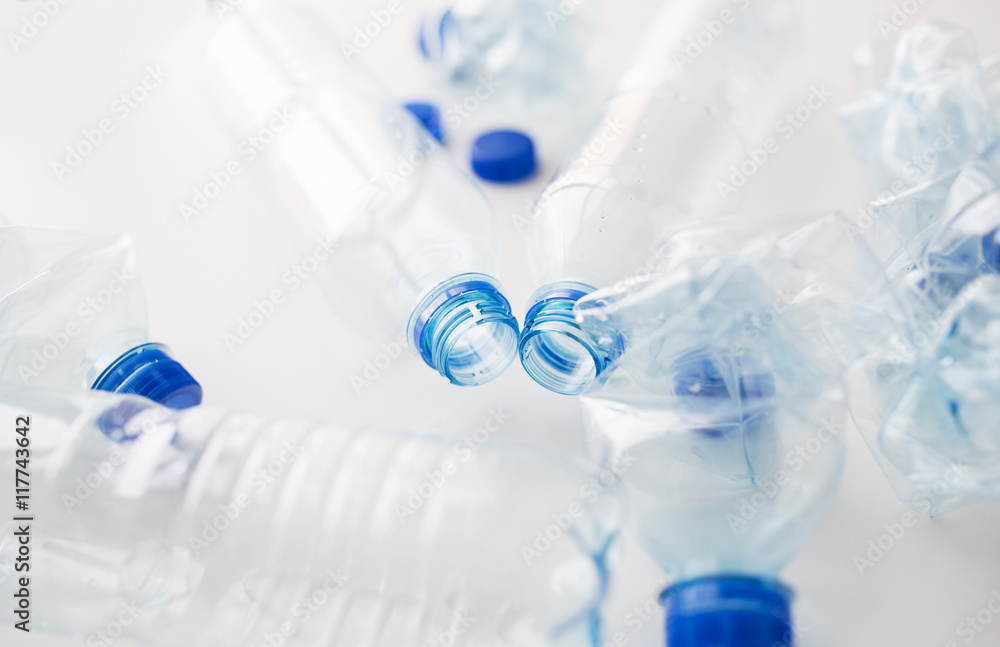 close up of empty used plastic bottles on table close up of empty used plastic bottles on table