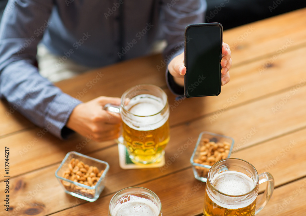 close up of friends with smartphone and beer close up of friends with smartphone and beer