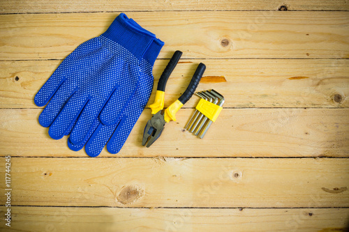 Tools and gloves on wooden table