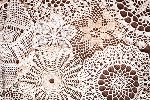 Beautiful delicate vintage lace background of crochet napkins on the table photo