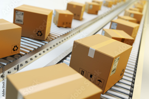 Packages delivery, packaging service and parcels transportation system concept, cardboard boxes on conveyor belt in warehouse