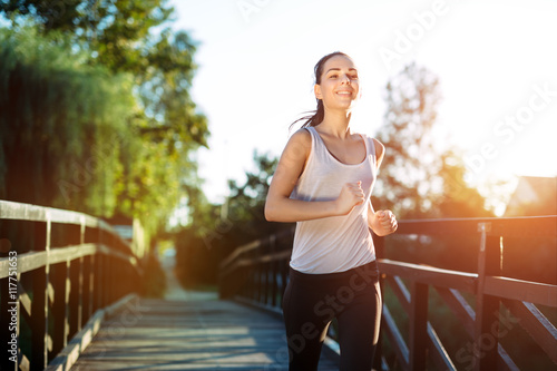 Fototapeta Naklejka Na Ścianę i Meble -  Athletic woman jogging in nature