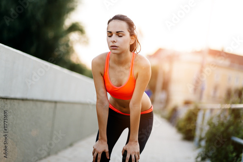 Tired female jogger resting