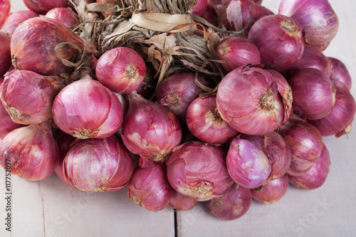 Shallot bundle on wooden table.