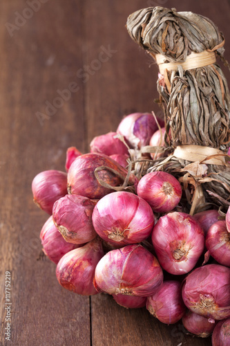 Shallot bundle on wooden table.