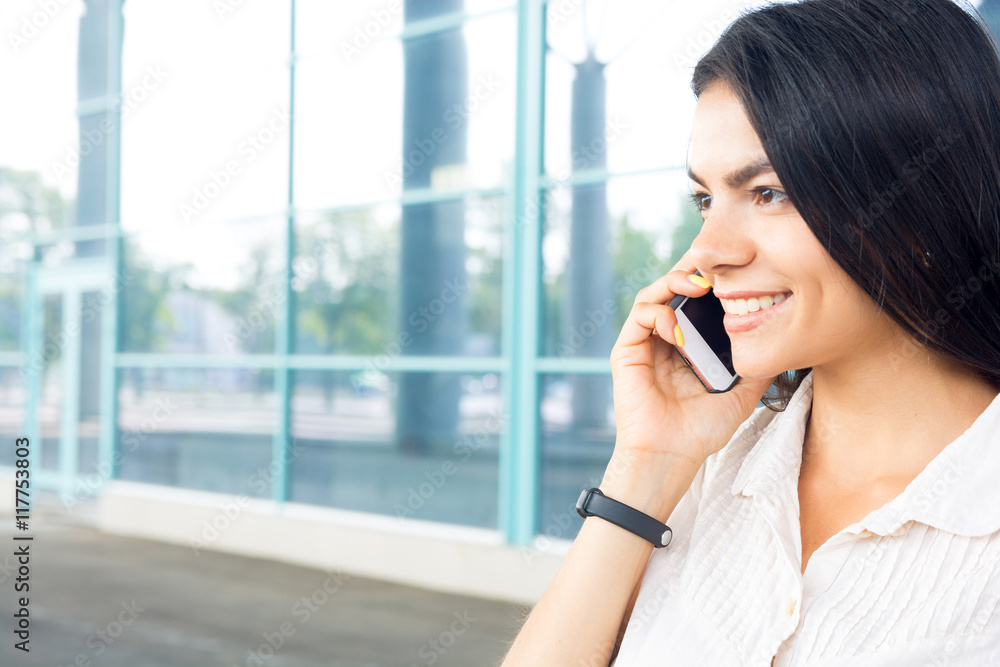 Successful businesswoman or entrepreneur talking by mobile phone Successful businesswoman or entrepreneur talking by mobile phone