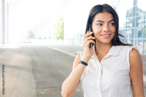 Woman talking on the phone taking a conversation