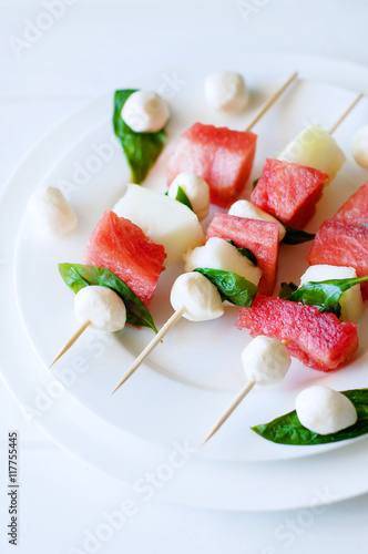 Watermelon kebab with spicy sauce, basil and mozzarella cheese