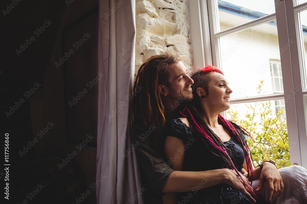 Hipster couple sitting by window Hipster couple sitting by window