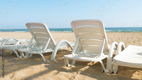 White chairs are placed on the beach for people to relax or sunbath. Beaches make a wonderful vacation spot. One of the most beautiful sceneries. © kirill4mula