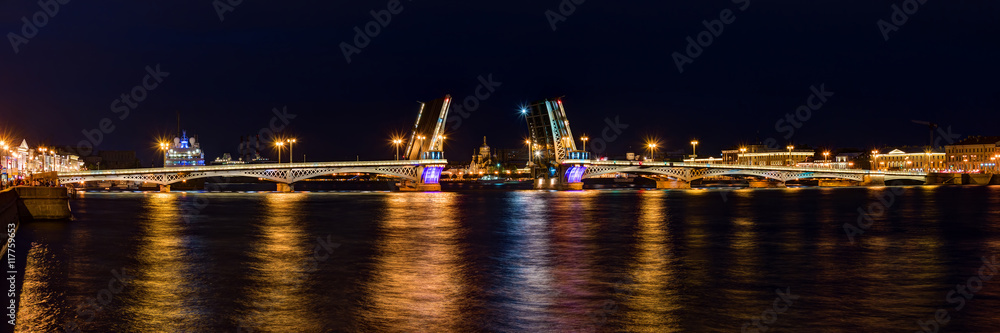 Night panoramic view on illuminated open Blagoveshchenskiy Bridge and Neva River, St. Petersburg, Russia.