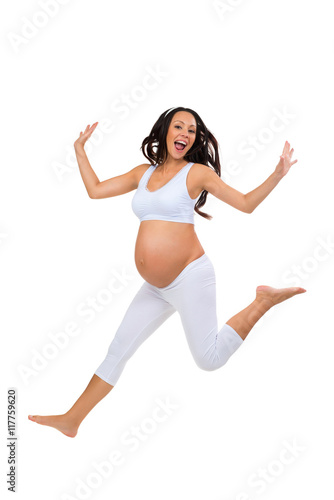 Happy pregnancy! Hooray! Emotional pregnant jumping for joy. Isolated on white background
