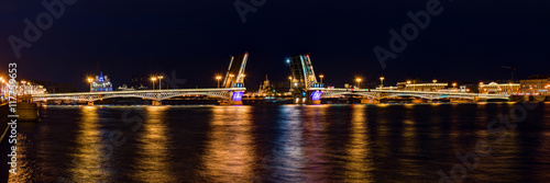 Night panoramic view on illuminated open Blagoveshchenskiy Bridge and Neva River, St. Petersburg, Russia. © dr_verner