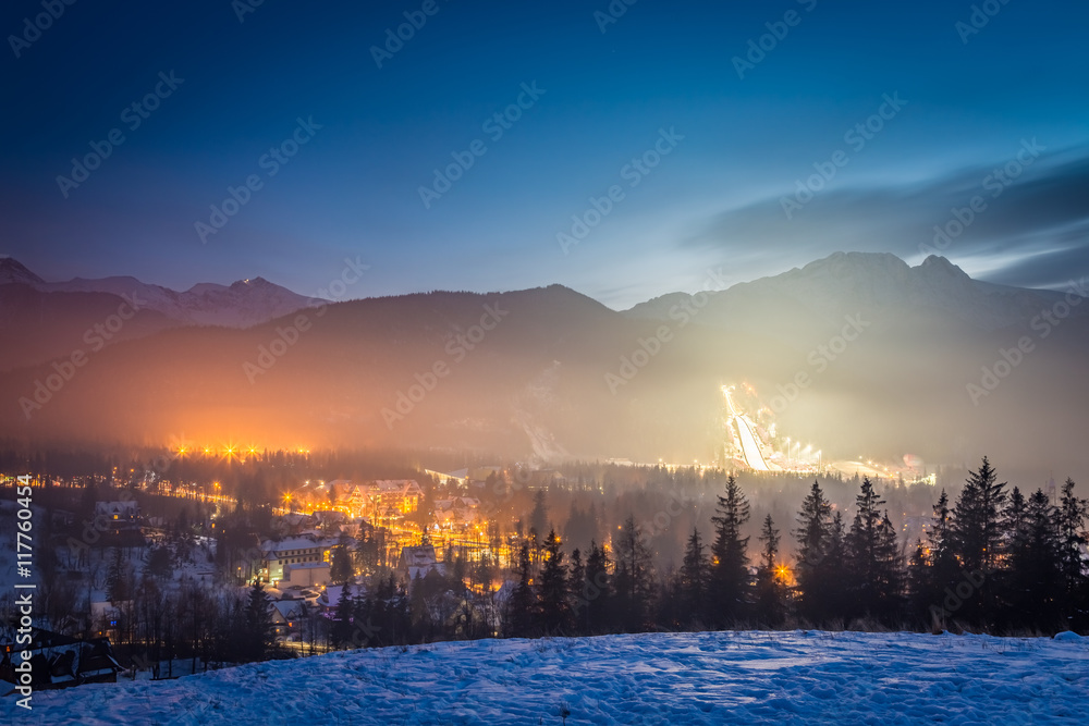 Skiing competitions in Zakopane in winter at dusk, Poland - obrazy, fototapety, plakaty 