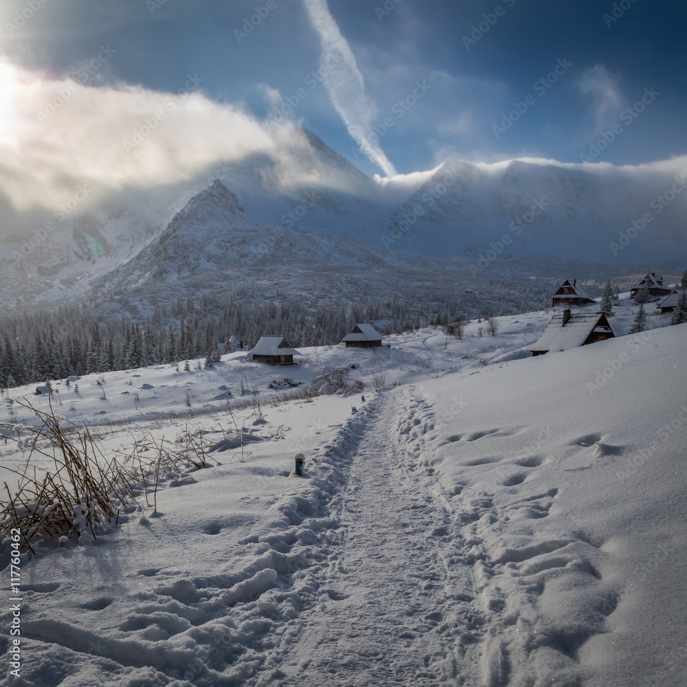 Winter mountain trail to a warm shelter, Tatras, Poland