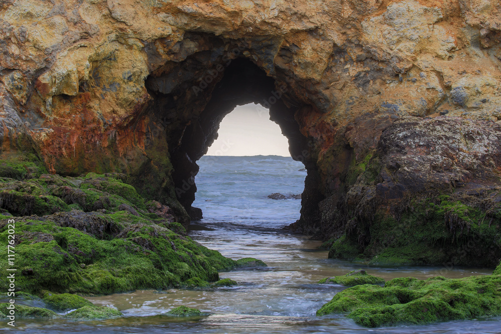 The Arch at Pescadero Beach, San Mateo County, California, USA. Pescadero Arch and Mossy Rocks of the Pacific Ocean.