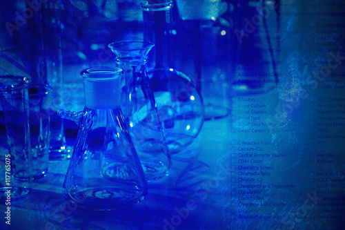 Laboratory glassware and test list on blue background