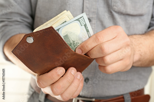 Man holding wallet with money, closeup