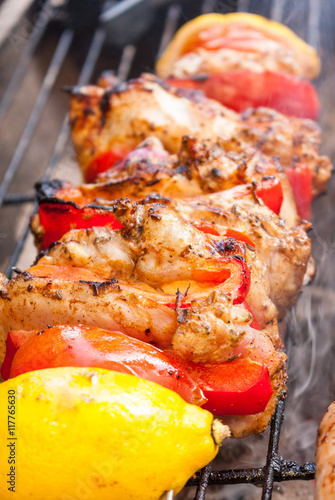 Close-up of a chicken shawarma kebab cooking on a on a barbecue