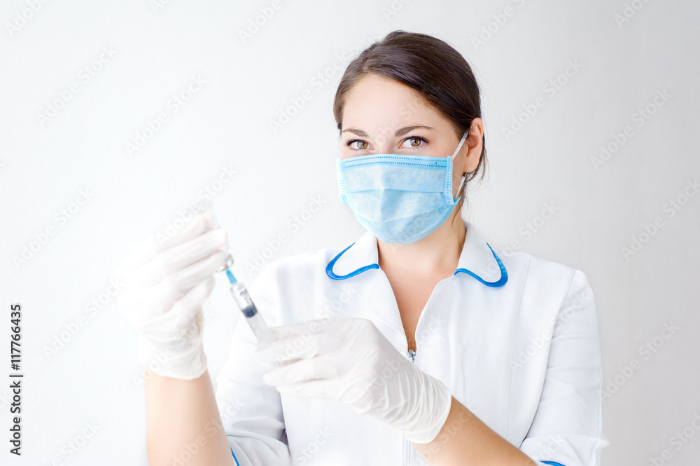 Girl, health worker dials the vaccine into a syringe Girl, health worker dials the vaccine into a syringe