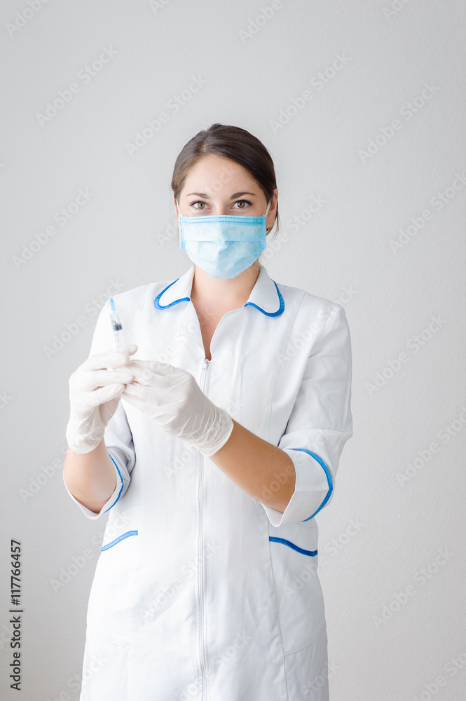 Girl, health worker dials the vaccine into a syringe Girl, health worker dials the vaccine into a syringe
