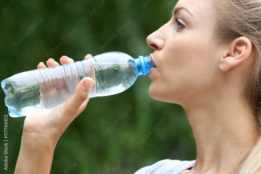 Beautiful girl drinking water on street Beautiful girl drinking water on street
