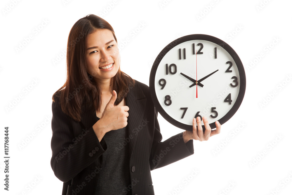Young Asian business woman thumbs up with a clock. Young Asian business woman thumbs up with a clock.