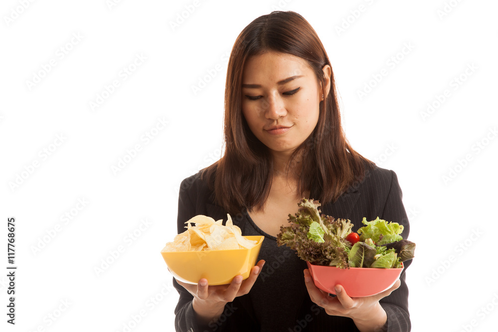 Young Asian business woman with potato chips and salad. Young Asian business woman with potato chips and salad.