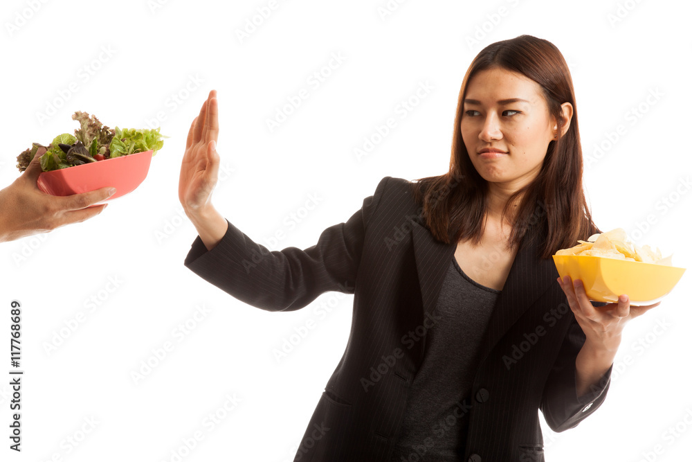 Young Asian woman with potato chips say no to salad. Young Asian woman with potato chips say no to salad.