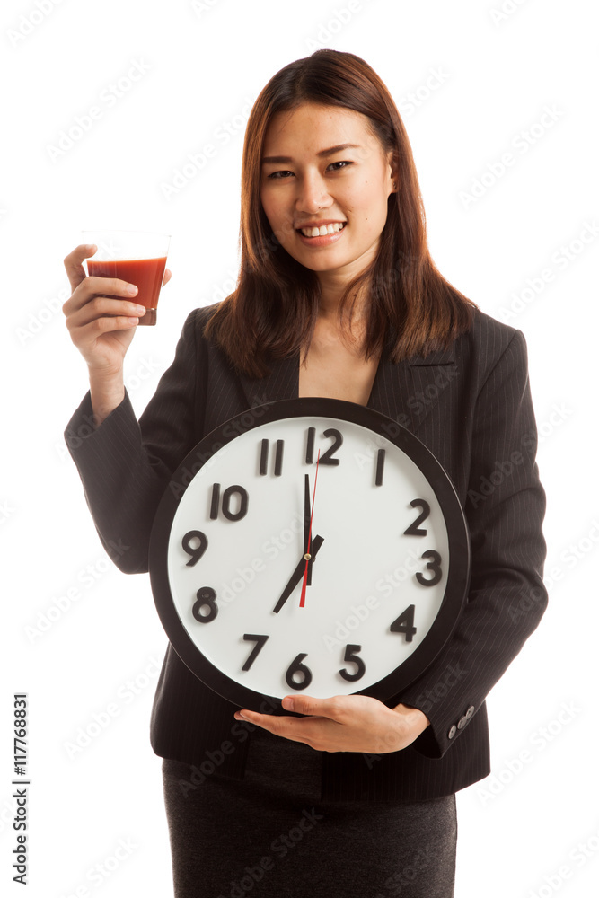 Young Asian business woman with tomato juice and clock. Young Asian business woman with tomato juice and clock.