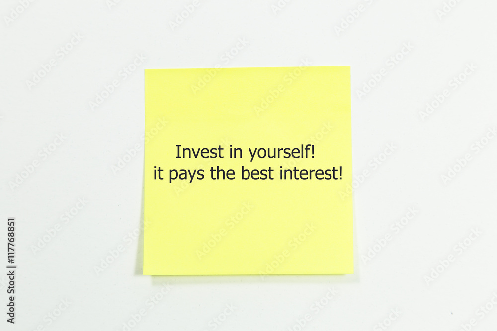 Invest in yourself, it pays the best interest word written on yellow sticky notes. Invest in yourself, it pays the best interest word written on yellow sticky notes.