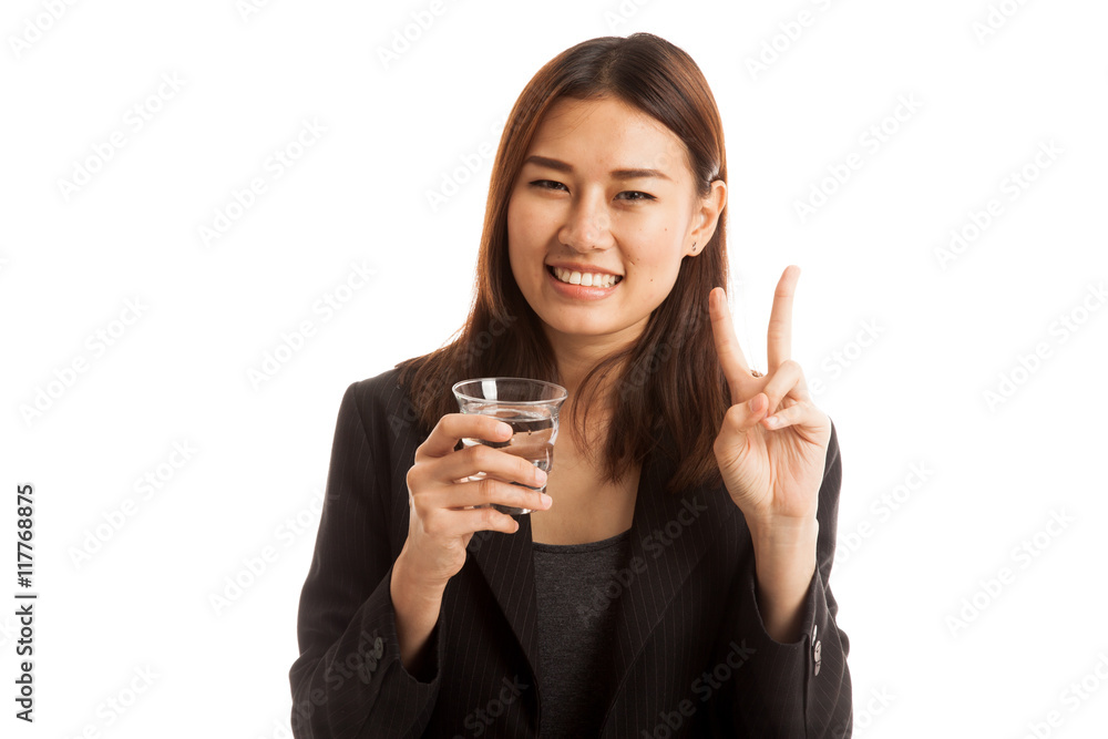 Young Asian woman show victory sign with a glass of drinking wat Young Asian woman show victory sign with a glass of drinking wat