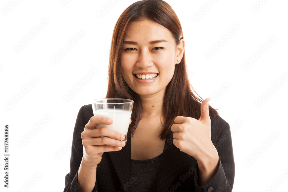 Healthy Asian woman drinking a glass of milk thumbs up. Healthy Asian woman drinking a glass of milk thumbs up.