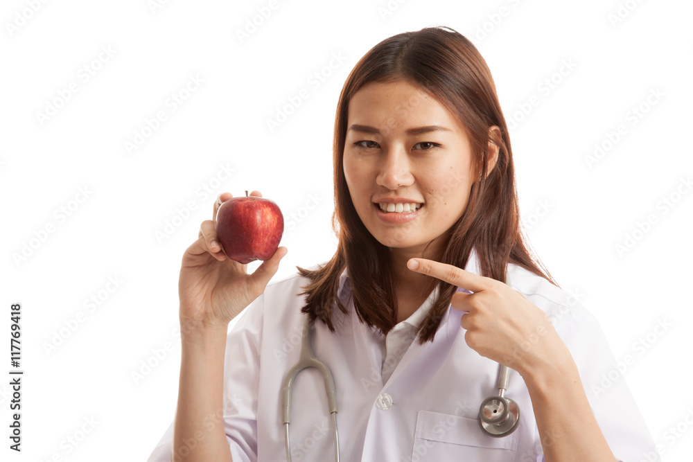 Young Asian female doctor point to an apple. Young Asian female doctor point to an apple.