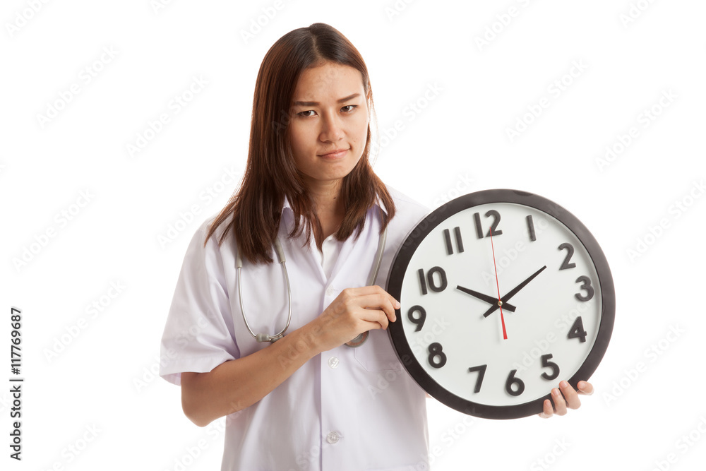 Frustrated Young Asian female doctor with a clock. Frustrated Young Asian female doctor with a clock.