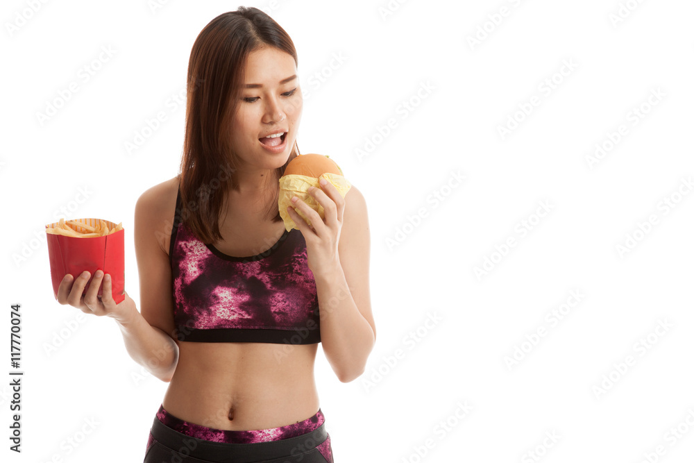 Beautiful Asian healthy girl with french fries and hamburger.